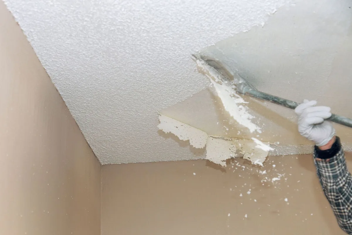 Close-up of white popcorn texture on an older residential ceiling.