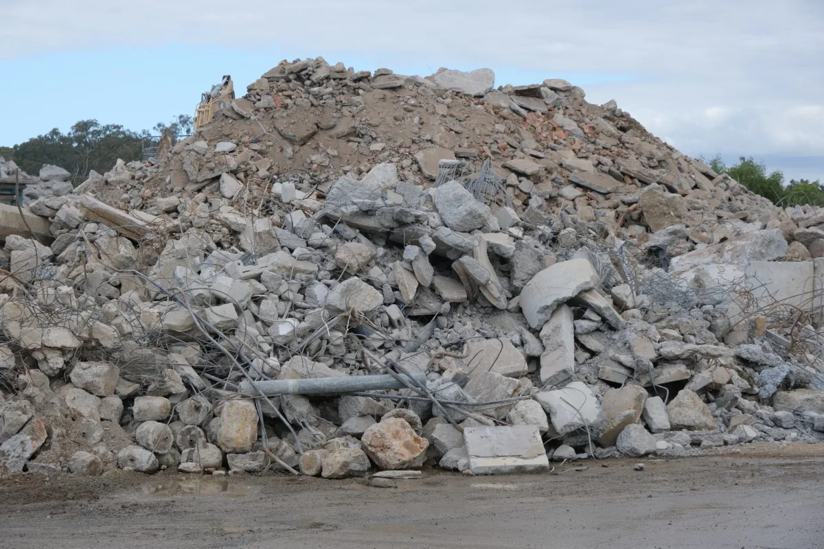 Broken concrete staged for recycling after demolition