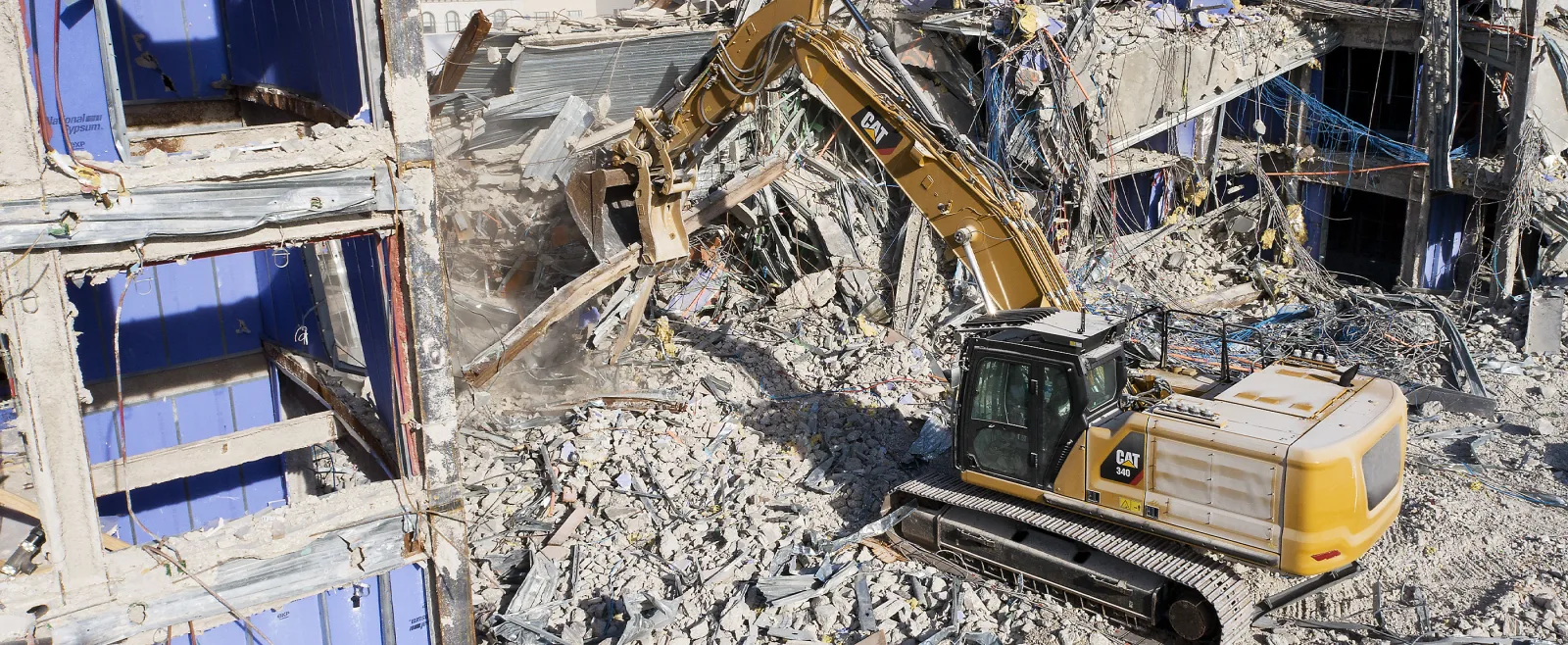 Excavator taking down a building during a demolition job
